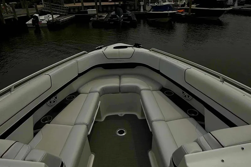Slide: The Image of 2020 Formula 290 Bowrider boat interior with spacious seating at a marina. - 19