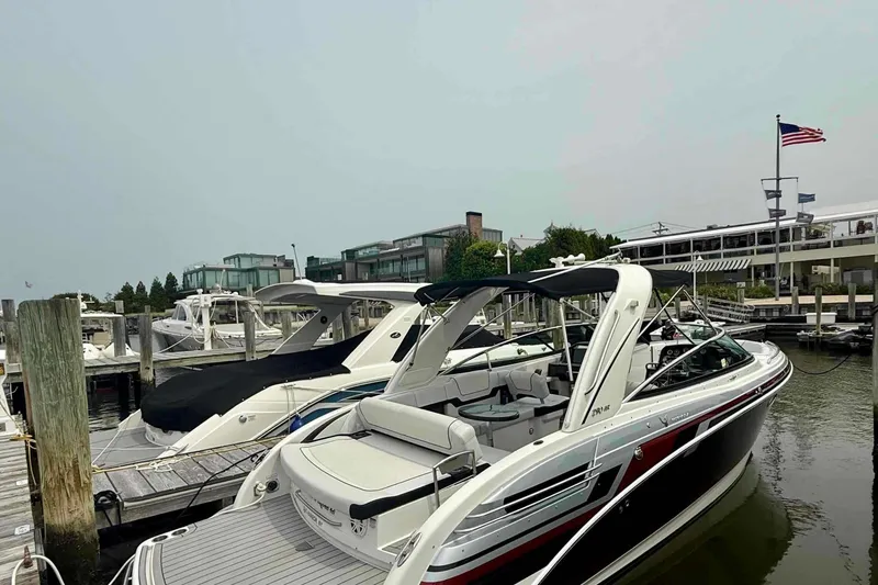 Slide: The Image of 2020 Formula 290 Bowrider docked at marina with American flag in background. - 3