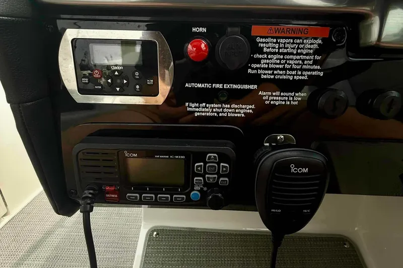 Slide: The Image of Control panel of a 2020 Formula 290 Bowrider with Icom VHF radio and warning labels. - 32