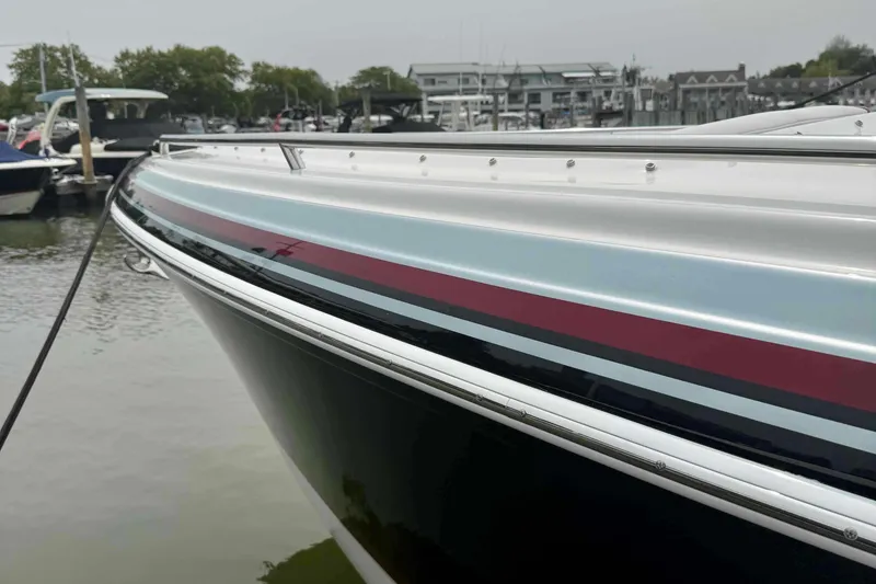Slide: The Image of 2020 Formula 290 Bowrider boat docked at a marina, showcasing sleek design and vibrant colors. - 5