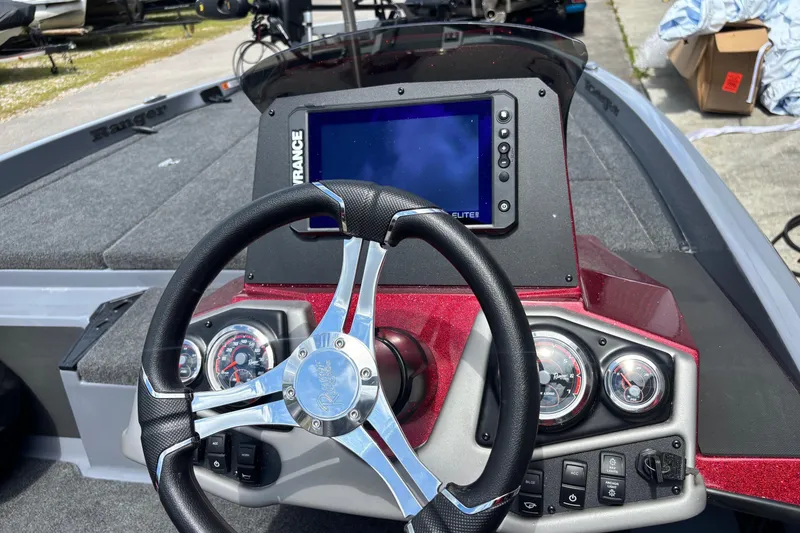 Slide: The Image of 2026 Ranger Z185 boat dashboard with steering wheel, gauges, and Lowrance Elite display. - 11