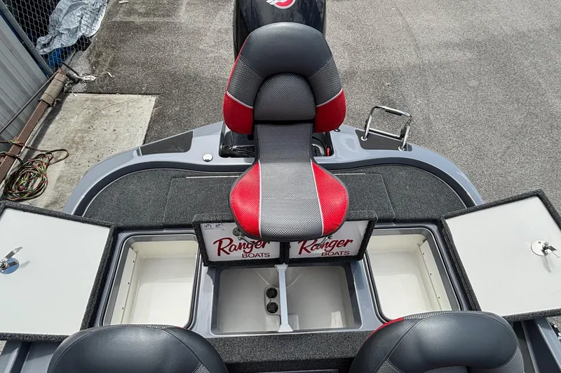 Slide: The Image of 2026 Ranger Z185 boat interior with red and gray seating, storage compartments open. - 14