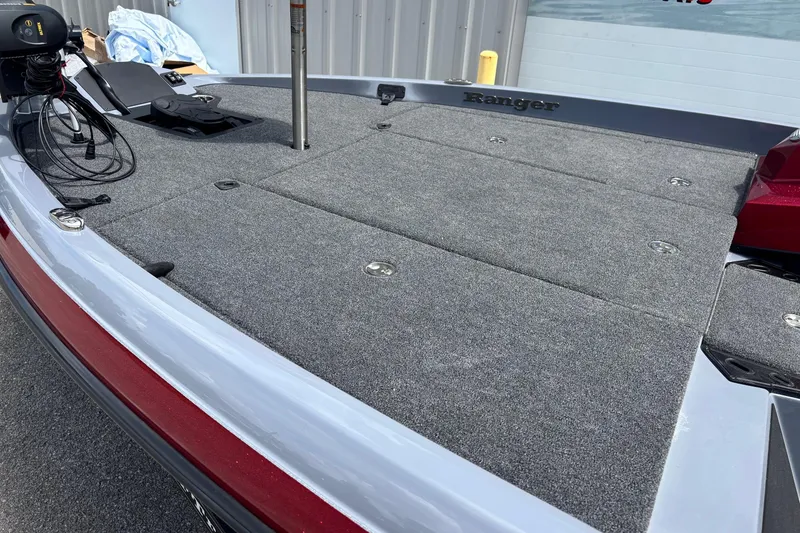 Slide: The Image of 2026 Ranger Z185 boat deck with gray carpet and fishing equipment. - 5