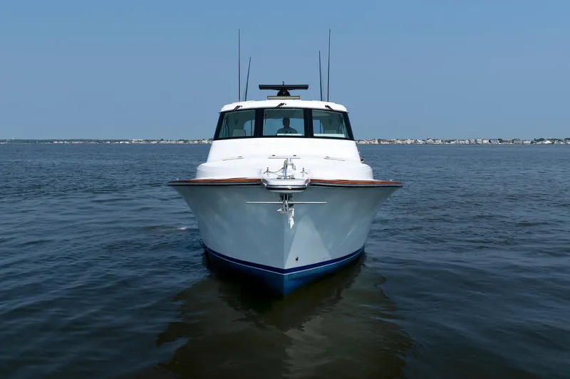 Slide: The Image of 2023 Henriques 42 Express Hardtop boat on calm water, front view. - 10