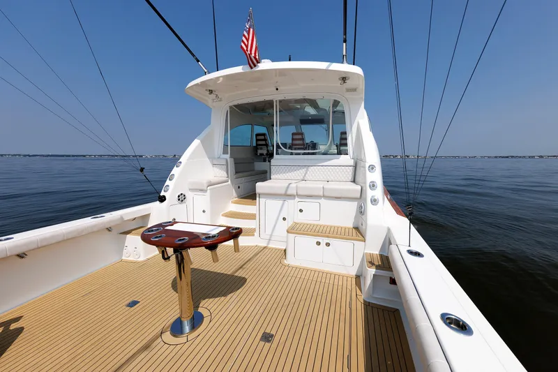 Slide: The Image of 2023 Henriques 42 Express Hardtop boat with spacious deck and fishing setup. - 16