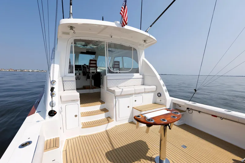 Slide: The Image of 2023 Henriques 42 Express Hardtop yacht interior with seating and fishing setup. - 18