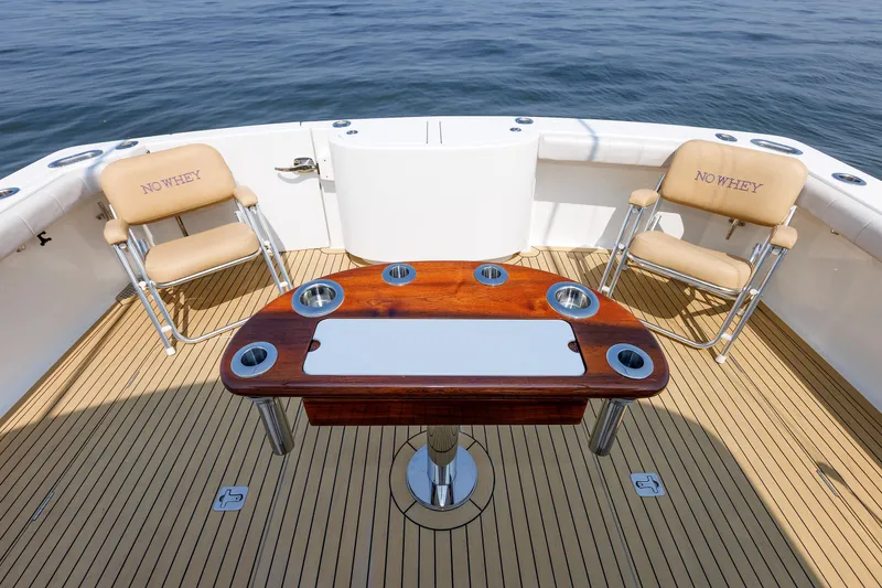 Slide: The Image of 2023 Henriques 42 Express Hardtop boat deck with chairs and table, ocean view. - 21