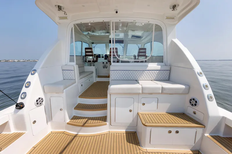 Slide: The Image of 2023 Henriques 42 Express Hardtop boat interior with seating and wooden flooring. - 25