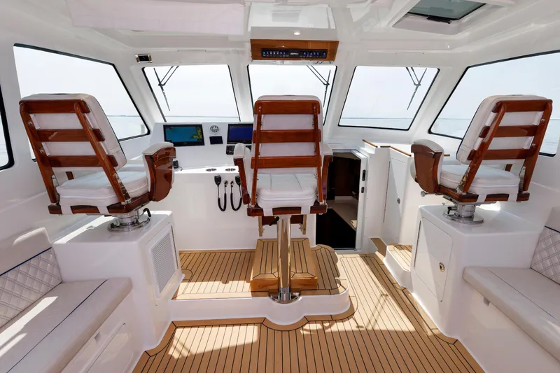 Slide: The Image of 2023 Henriques 42 Express Hardtop interior with helm chairs and navigation equipment. - 30