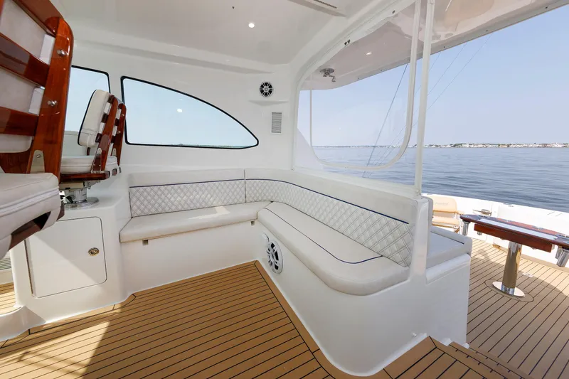 Slide: The Image of 2023 Henriques 42 Express Hardtop interior with elegant seating and ocean view. - 32