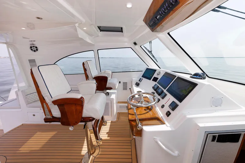 Slide: The Image of 2023 Henriques 42 Express Hardtop yacht interior with modern helm and seating. - 34