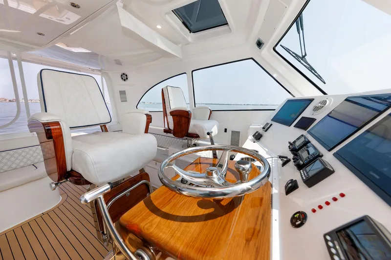Slide: The Image of Luxurious interior of 2023 Henriques 42 Express Hardtop yacht with modern helm and seating. - 35