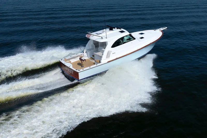 Slide: The Image of 2023 Henriques 42 Express Hardtop cruising on open water, showcasing sleek design and performance. - 4