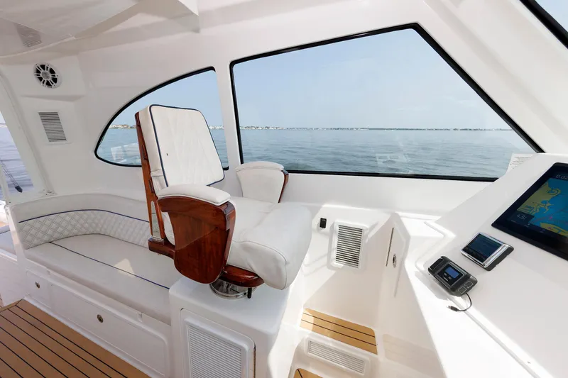 Slide: The Image of 2023 Henriques 42 Express Hardtop interior with helm seat and navigation display. - 40