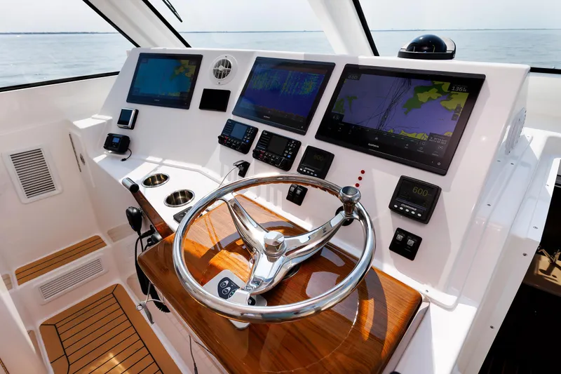 Slide: The Image of Helm of 2023 Henriques 42 Express Hardtop with advanced navigation displays and controls. - 42