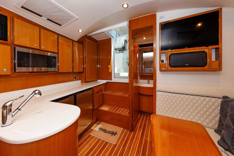 Slide: The Image of Luxurious interior of 2023 Henriques 42 Express Hardtop yacht with modern kitchen and seating area. - 46