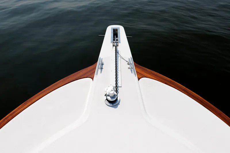 Slide: The Image of Bow of 2023 Henriques 42 Express Hardtop yacht with anchor chain over water. - 55