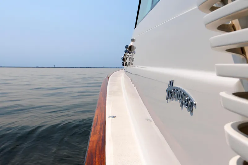 Slide: The Image of 2023 Henriques 42 Express Hardtop yacht on calm water, side view. - 60