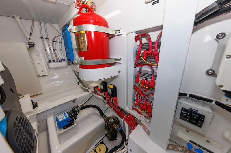 Slide: The Image of Engine room of 2023 Henriques 42 Express Hardtop with fire extinguisher and electrical systems. - 68