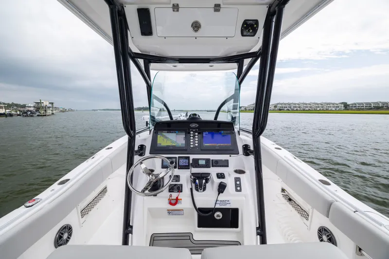 Slide: The Image of 2023 Sea Fox 268 Commander boat cockpit with modern navigation system on a calm waterway. - 11