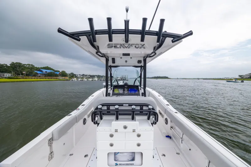 Slide: The Image of 2023 Sea Fox 268 Commander boat on calm water, featuring spacious deck and modern design. - 12