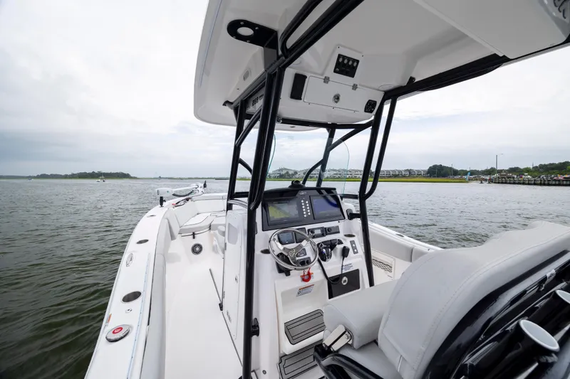 Slide: The Image of 2023 Sea Fox 268 Commander boat interior with steering console on open water. - 13