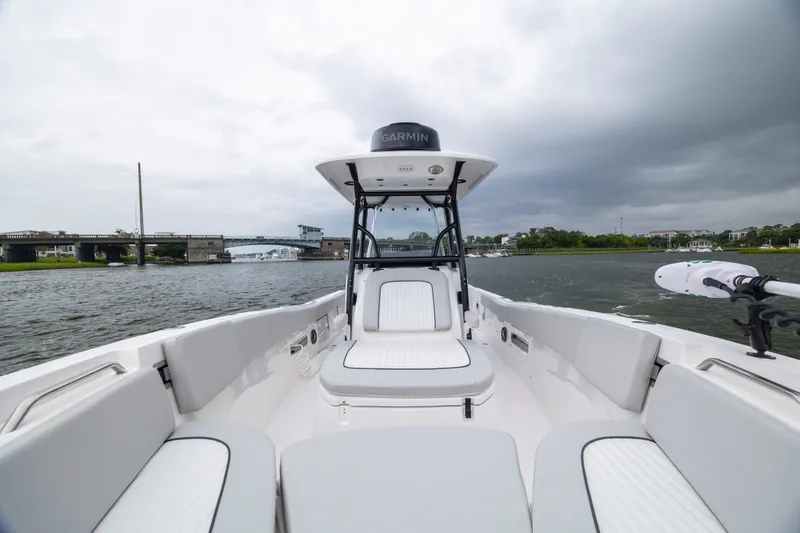 Slide: The Image of 2023 Sea Fox 268 Commander boat on water, cloudy sky, bridge in background. - 15