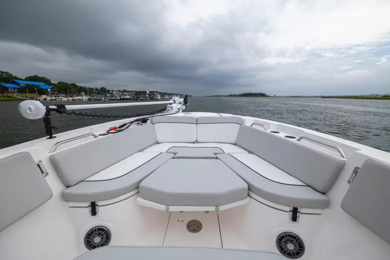 Slide: The Image of 2023 Sea Fox 268 Commander boat interior with cushioned seating on a cloudy day. - 17