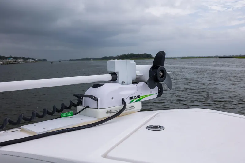 Slide: The Image of 2023 Sea Fox 268 Commander with trolling motor on calm water under cloudy sky. - 20