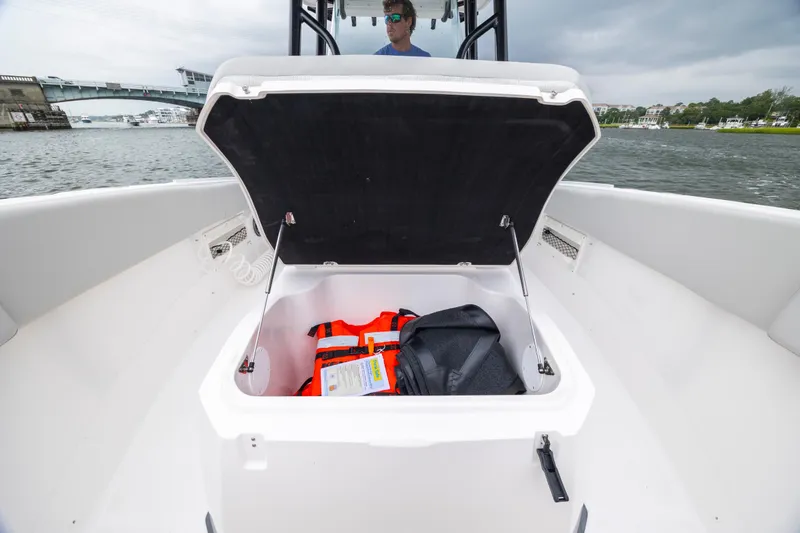 Slide: The Image of 2023 Sea Fox 268 Commander boat storage compartment with life jacket and bag. - 21