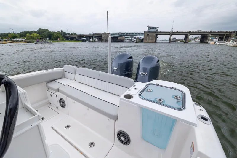 Slide: The Image of 2023 Sea Fox 268 Commander boat with twin engines on a river near a bridge. - 23