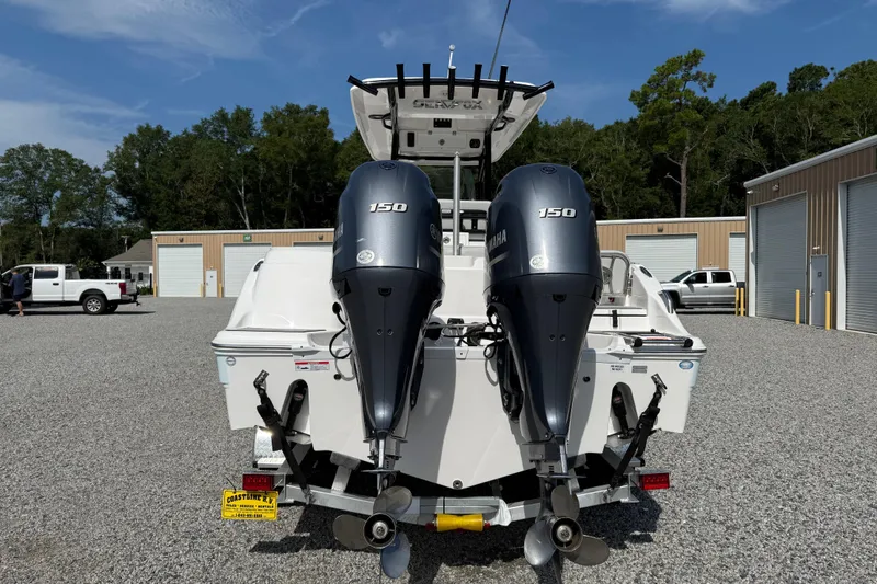 Slide: The Image of 2023 Sea Fox 268 Commander with dual Yamaha 150 engines, parked outdoors. - 33