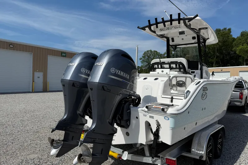Slide: The Image of 2023 Sea Fox 268 Commander boat with dual Yamaha engines, parked outdoors. - 34