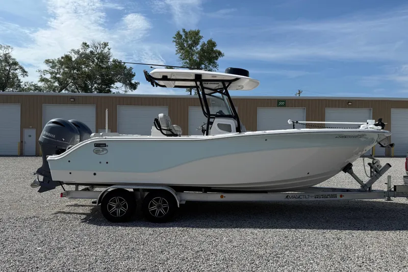 Slide: The Image of 2023 Sea Fox 268 Commander boat on trailer, parked outdoors under clear sky. - 36