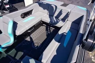 Slide: The Image of 2025 MasterCraft NXT23 boat interior with gray and teal seating, showcasing modern design. - 11