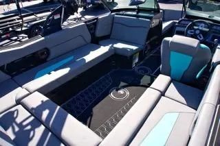 Slide: The Image of 2025 MasterCraft NXT23 boat interior with modern seating and sleek design. - 12
