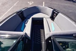 Slide: The Image of 2025 MasterCraft NXT23 boat interior with gray seating and modern design. - 9