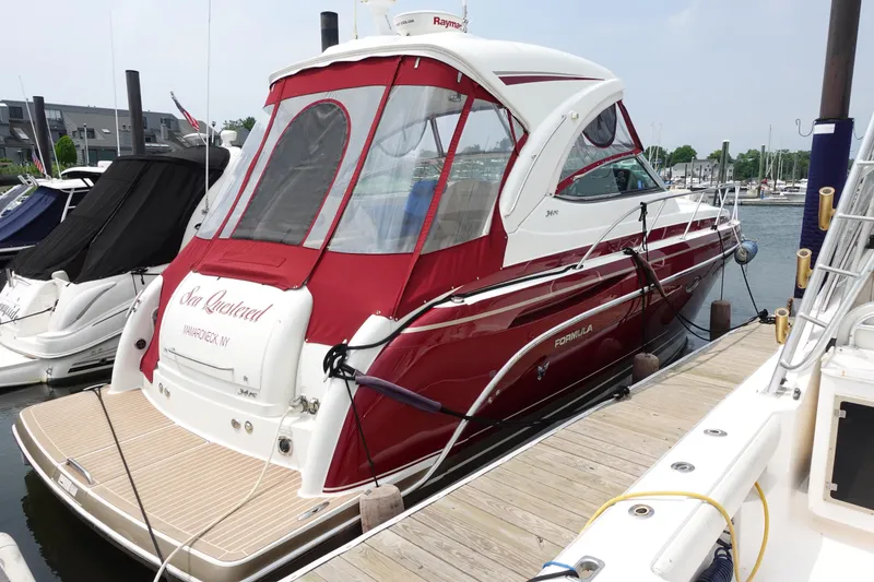 The Image of 2016 Formula 34 Cruiser docked, featuring red and white design, in a marina setting. - 0