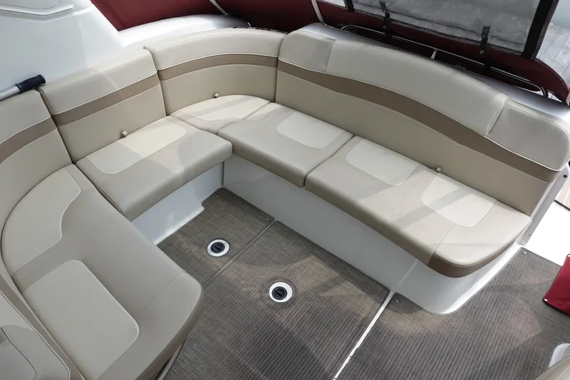 Slide: The Image of 2016 Formula 34 Cruiser interior seating with beige upholstery and carpeted flooring. - 13