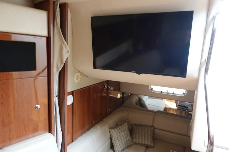 Slide: The Image of Interior of 2016 Formula 34 Cruiser with TV, wood cabinets, and beige seating. - 18
