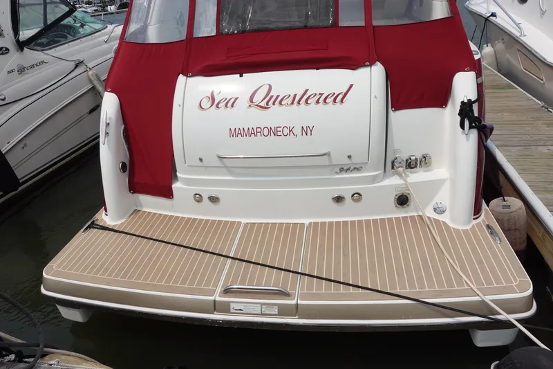 Slide: The Image of 2016 Formula 34 Cruiser boat docked, featuring red canopy and "Sea Questered" name. - 2