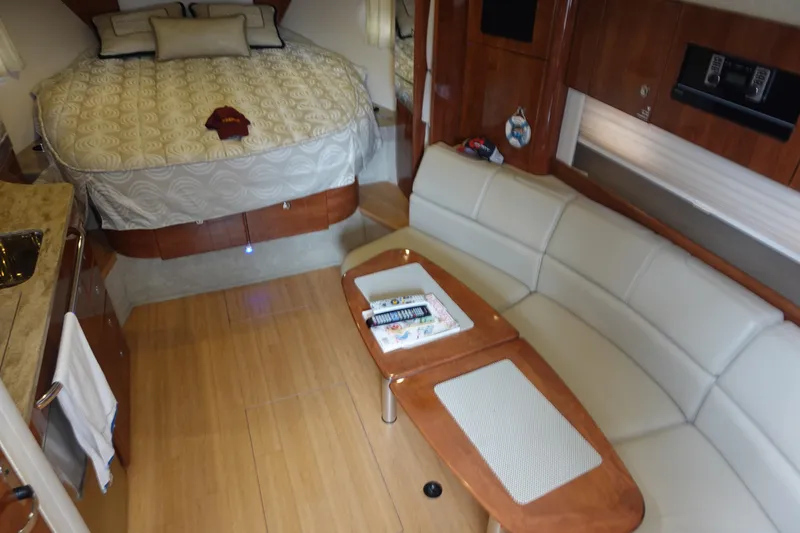Slide: The Image of 2016 Formula 34 Cruiser interior with bed, sofa, and wooden table. - 20