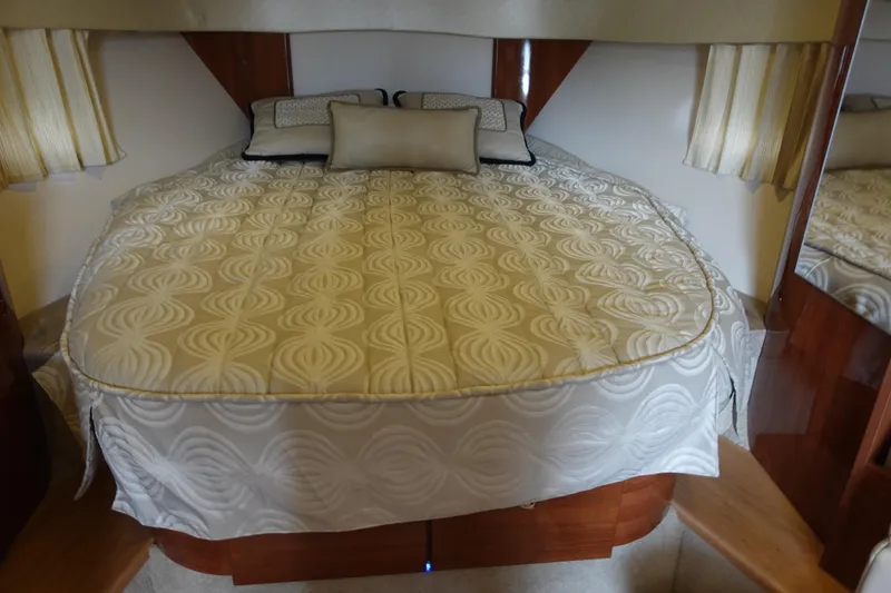 Slide: The Image of Luxurious bedroom interior of 2016 Formula 34 Cruiser with elegant bedding and wood accents. - 23