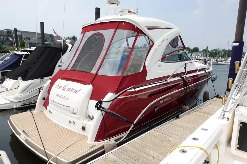 Slide: The Image of 2016 Formula 34 Cruiser docked at marina, featuring red and white design. - 4