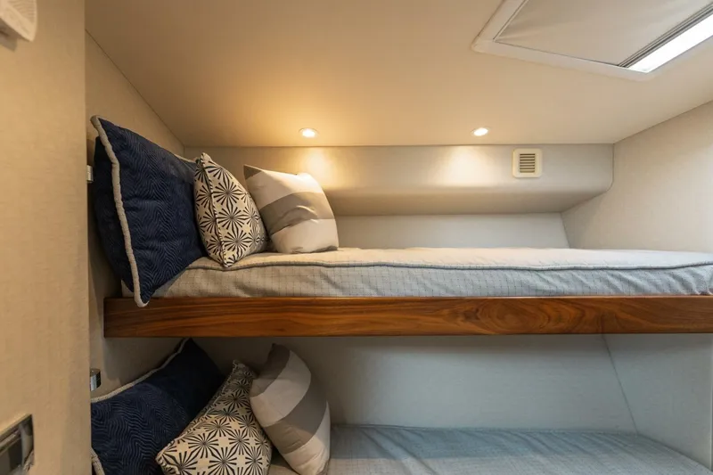 Slide: The Image of Bunk beds with decorative pillows in 2018 Hatteras GT45X Flybridge yacht cabin. - 11