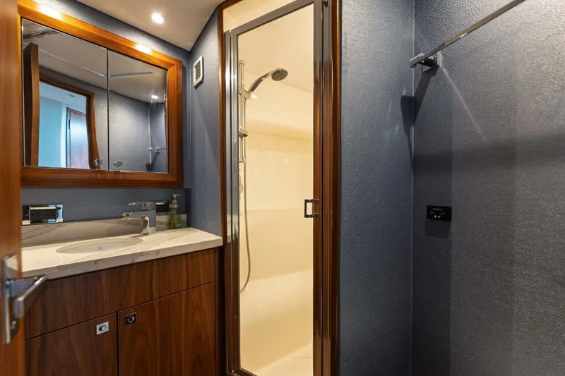Slide: The Image of Luxurious bathroom in 2018 Hatteras GT45X Flybridge yacht with modern fixtures and elegant design. - 12