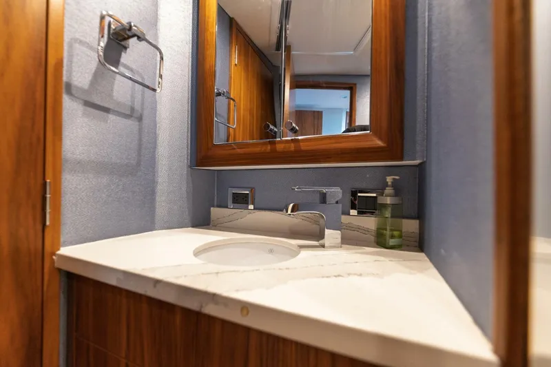 Slide: The Image of Luxurious bathroom vanity on 2018 Hatteras GT45X Flybridge yacht with marble countertop. - 13