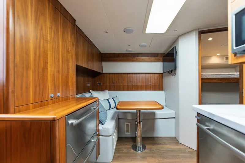 Slide: The Image of Luxurious interior of 2018 Hatteras GT45X Flybridge yacht with wood finishes and cozy seating. - 3