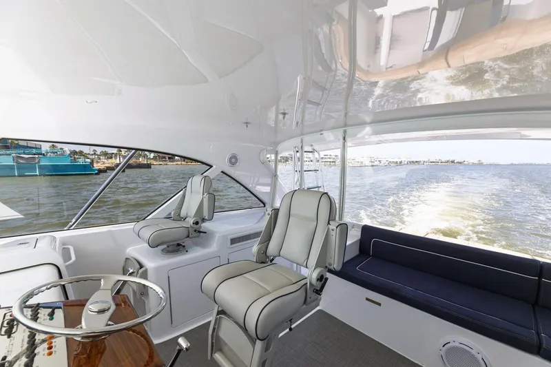 Slide: The Image of 2018 Hatteras GT45X Flybridge interior with helm seats and ocean view. - 40