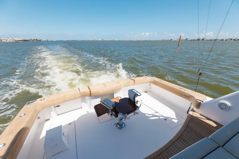 Slide: The Image of 2018 Hatteras GT45X Flybridge yacht cruising on open water, showcasing spacious deck. - 42